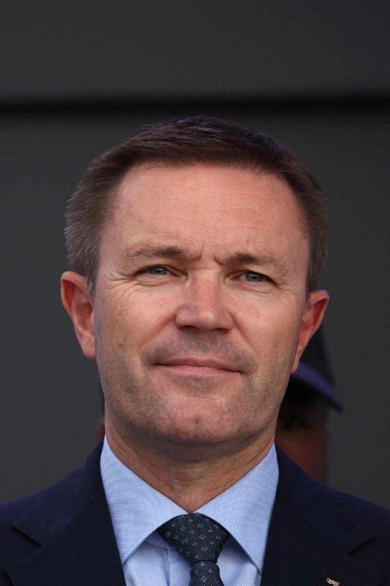 UCI President David Lappartient stand with medal winners on the podium following the team time trial mixed relay cycling event during the UCI 2025 Road World Championships, in Kigali, on September 24, 2025.  Anne-Christine POUJOULAT / AFP