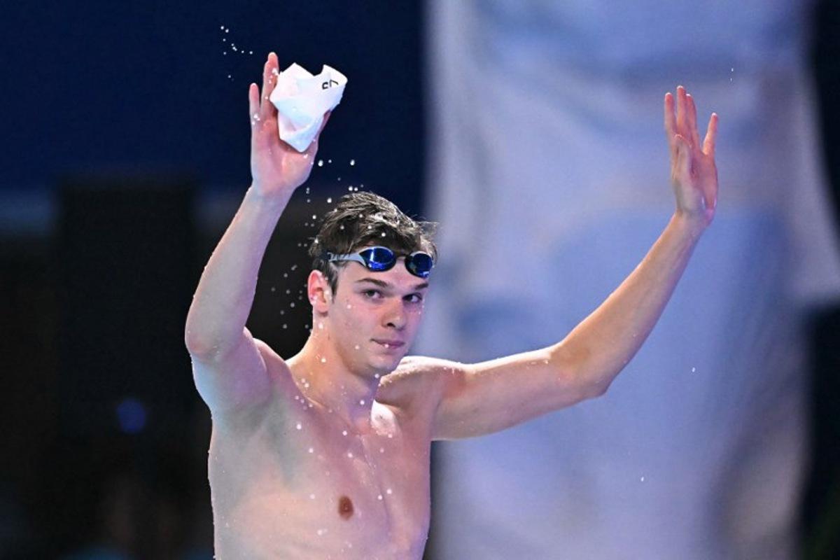 Hungary's swimmer Hubert Kos celebrates after the final of the men's 200m backstroke swimming event during the 2025 World Aquatics Championships in Singapore on August 1, 2025.  MANAN VATSYAYANA / AFP