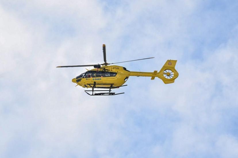 This photograph shows a helicopter transporting US' Lindsey Vonn after a stop in Cortina, following her crash in the women's downhill event during the Milano Cortina 2026 Winter Olympic Games, in Cortina d'Ampezzo on February 8, 2026. Lindsey Vonn crashed out of the Winter Olympics downhill on February 8, 2026, brutally ending the American skiing great's improbable dream of winning a medal despite competing with a ruptured anterior cruciate ligament.  Tiziana FABI / AFP