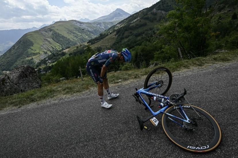 Soudal Quick-Step team's Belgian rider Ilan Van Wilder awaits technical assistance on the roadside during the 20th stage of the 113th edition of the Tour de France cycling race, 170,9 km between Le Bourg-d'Oisans and Alpe d'Huez in the French Alps, on July 25, 2026.  Loic VENANCE / AFP