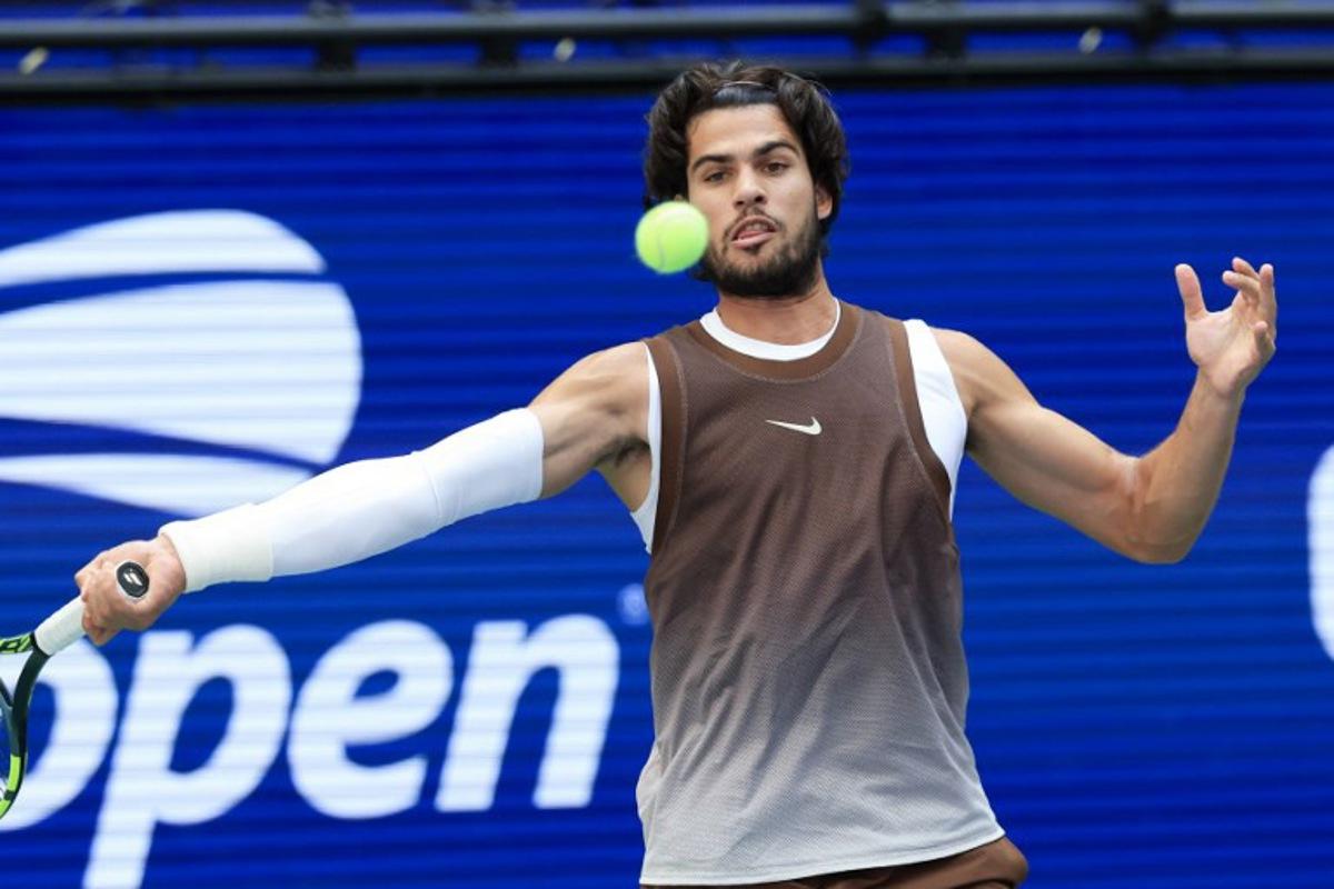 Spain's Carlos Alcaraz hits a return to China's Wu Yibing during their men's singles third round tennis match on day six of the US Open tennis tournament at the USTA Billie Jean King National Tennis Center in New York City on September 4, 2026.  TIMOTHY A. CLARY / AFP