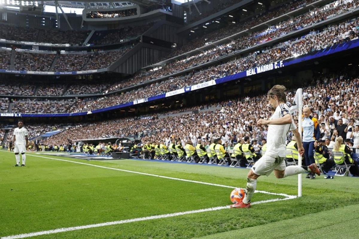 Real Madrid's Croatian midfielder #10 Luka Modric takes a corner during the Spanish league football match between Real Madrid CF and Real Sociedad at Santiago Bernabeu Stadium in Madrid on May 24, 2025.  OSCAR DEL POZO / AFP
