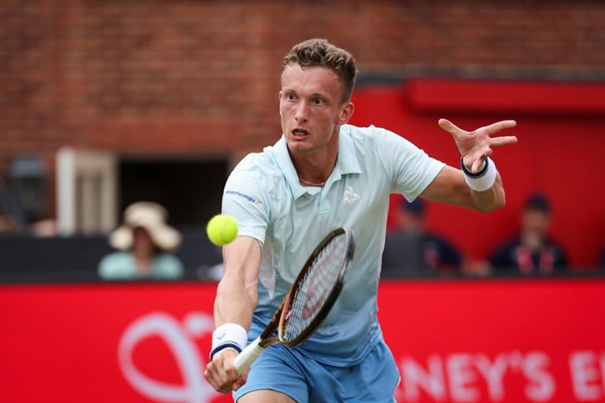 Czech Republic's Jiri Lehecka plays a backhand return to Britain's Jack Draper during their men's singles semi-final tennis match at the HSBC ATP tennis Championships at Queen's Club in west London on June 21, 2025.  Adrian Dennis / AFP