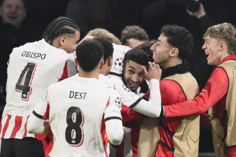 PSV Eindhoven's Moroccan midfielder #34 Ismael Saibari (3R) celebrates with teammates after scoring his team's first goal during the UEFA Champions League league phase day 8 football match between PSV Eindhoven and Bayern Munich at Philips Stadion in Eindhoven on January 28, 2026.  JOHN THYS / AFP