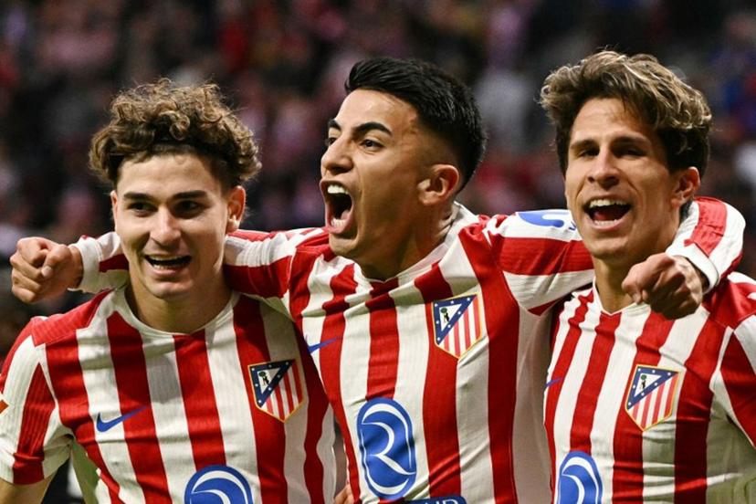 Atletico Madrid's Argentine midfielder #11 Thiago Almada (C) celebrates scoring his team's second goal with Atletico Madrid's Argentine forward #19 Julian Alvarez (L) and Atletico Madrid's Argentine forward #20 Giuliano Simeone during the Spanish League football match between Club Atletico de Madrid and Sevilla FC at Metropolitano Stadium in Madrid on November 1, 2025.  JAVIER SORIANO / AFP