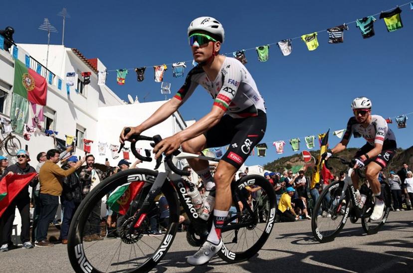 UAE Team Emirates XRG Portuguese cyclist Joao Almeida (L) rides in Alte during the second stage of the 52nd edition of the Volta ao Algarve, a 147.2 km race between Portimao and Foia, Monchique, on February 19, 2026.  João Matos / AFP