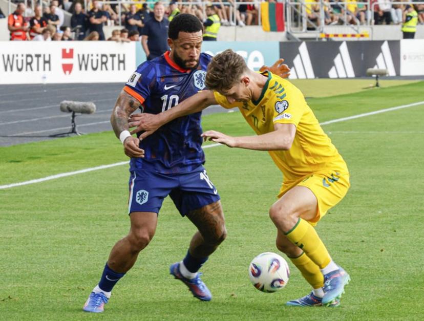 Netherlands' forward #10 Memphis Depay (L) and Lithuania's midfielder #22 Paulius Golubickas vie for the ball during the 2026 World Cup qualifiers Europe zone group G football match between Lithuania and The Netherlands, on September 7, 2025 in Kaunas, Lithuania.  Petras Malukas / AFP