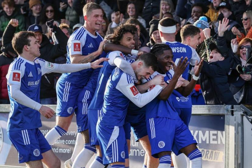 Macclesfield's English striker #07 Isaac Buckley-Ricketts (R) celebrates with teammates after scoring the team's second goal during the English FA Cup third round football match between Macclesfield Town and Crystal Palace at Leasing.com Stadium, Moss Rose in Macclesfield, northern England on January 10, 2026.  Darren Staples / AFP