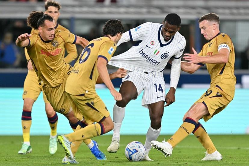 Inter Milan's French forward #14 Ange-Yoan Bonny (C) fights for the ball with Bologna's Belgian defender #03 Arthur Theate (L) and Bologna's Scottish midfielder #19 Lewis Ferguson (R) during the Italian Serie A football match between Bologna and Inter Milan at the Renato Dall'Ara stadium in Bologna on October 17, 2026.  Stefano RELLANDINI / AFP