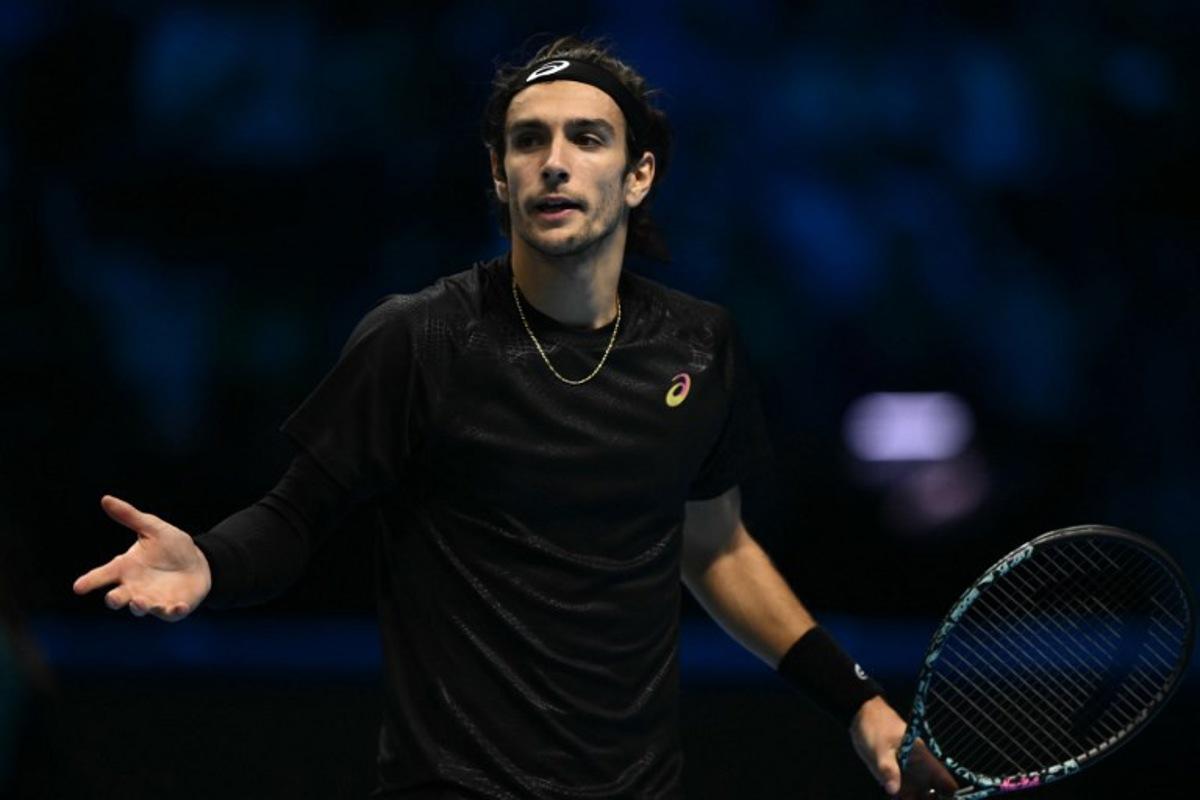 Italy's Lorenzo Musetti reacts during his match against Spain's Carlos Alcaraz at the ATP Finals tennis tournament in Turin on November 13, 2025.  Marco BERTORELLO / AFP