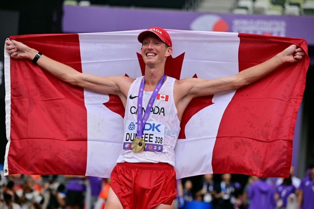 Gold medallist Canada's athlete Evan Dunfee celebrates with his medal after winning the men's 35km race walk final during the World Athletics Championships in Tokyo on September 13, 2025.  Ben STANSALL / AFP