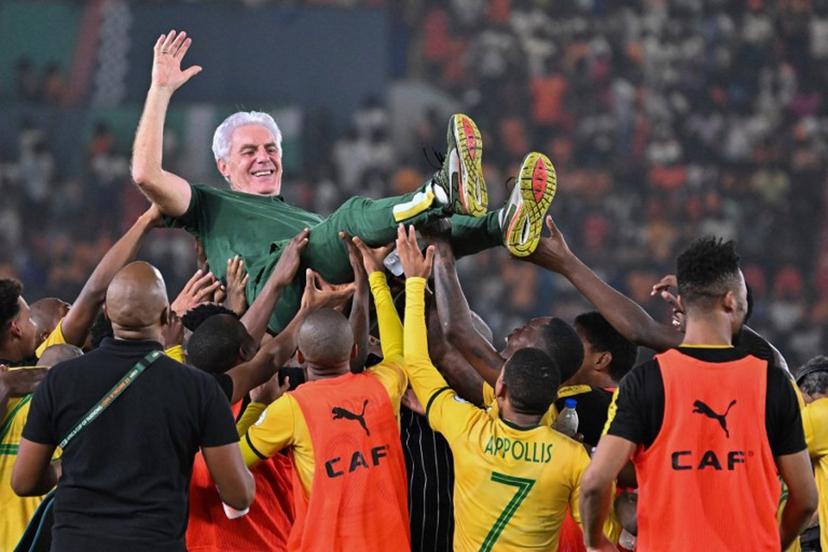 South Africa's head coach Hugo Broos is lifted in the air by South African players after they won the Africa Cup of Nations (CAN) 2024 third place play-off football match between South Africa and Democratic Republic of Congo at Felix Houphouet-Boigny Stadium in Abidjan on February 10, 2024.  Sia KAMBOU / AFP