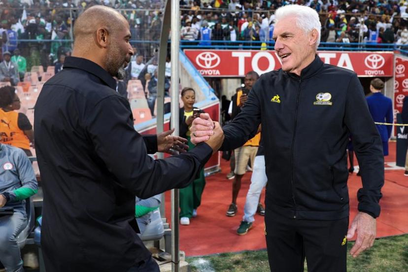 Nigeria's coach Eric Chelle (L) greets South Africa's Belgian coach Hugo Broos (R) ahead of the FIFA World Cup 2026 Africa qualifiers group C match between South Africa and Nigeria at the Free State Stadium in Bloemfontein on September 9, 2025.  Phill Magakoe / AFP