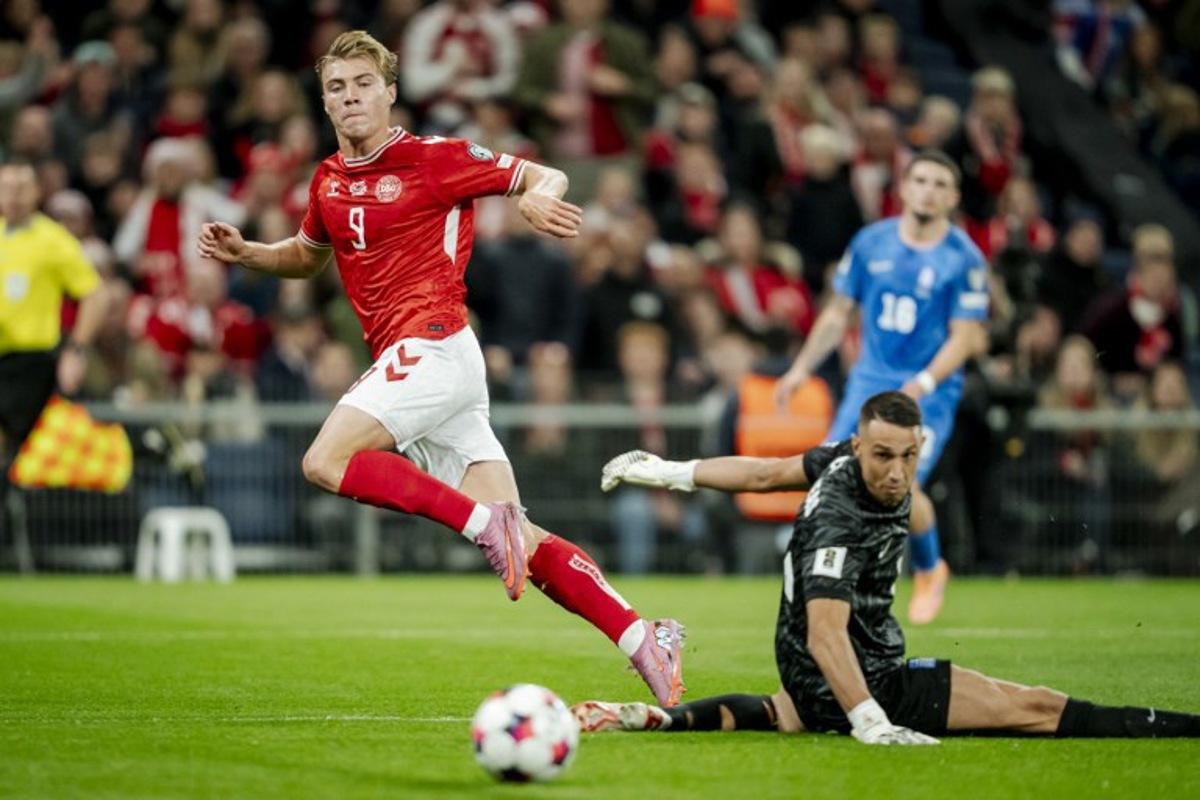 Denmark's forward #09 Rasmus Hojlund scores his team's first goal during the 2026 World Cup qualifiers Europe zone group G football match between Denmark and Greece on October 12, 2025 in Copenhagen.   Mads Claus Rasmussen / Ritzau Scanpix / AFP