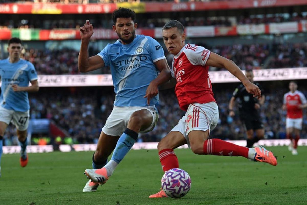 Manchester City's Portuguese midfielder #27 Matheus Nunes (L) vies with Arsenal's Belgian midfielder #19 Leandro Trossard (R) during the English Premier League football match between Arsenal and Manchester City at the Emirates Stadium in London on September 21, 2025.   Glyn KIRK / AFP