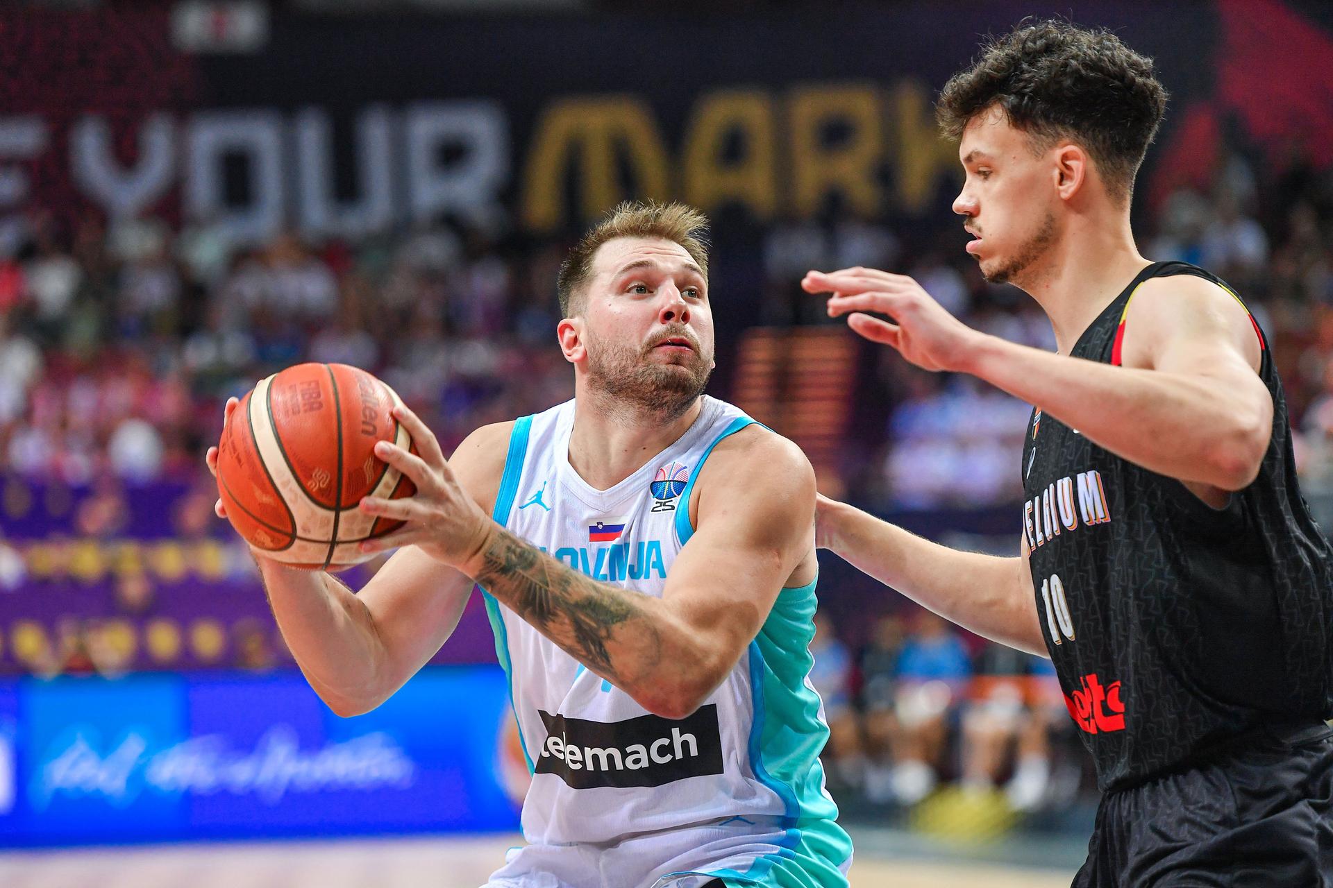 Slovenian Luka Doncic and Belgium's Hans Vanwijn pictured in action during a basketball match between Belgium's national team Belgian Lions and Slovenia, Sunday 31 August 2025 in Katowice, Poland, the third game of the group stage of the Eurobasket 2025 European championships. BELGA PHOTO MARCIN BULANDA *** BELGIUM ONLY ***