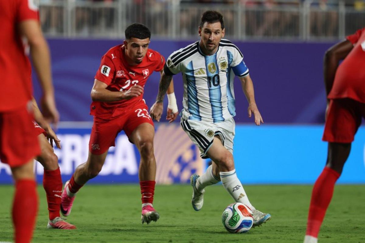 Argentina's forward #10 Lionel Messi runs with the ball followed by Switzerland's forward #23 Zeki Amdouni during the 2026 World Cup football tournament quarter-final match between Argentina and Switzerland at the Kansas City Stadium in Kansas City on July 11, 2026.   Odd ANDERSEN / AFP