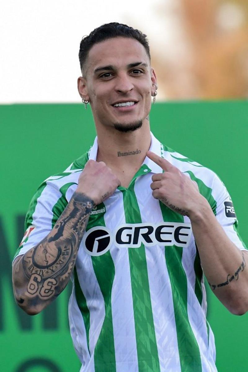 Real Betis' new Brazilian player Antony Santos points to a tattoo during his presentation at the Ciudad Deportivo Luis del Sol in Seville on February 5, 2025.  CRISTINA QUICLER / AFP