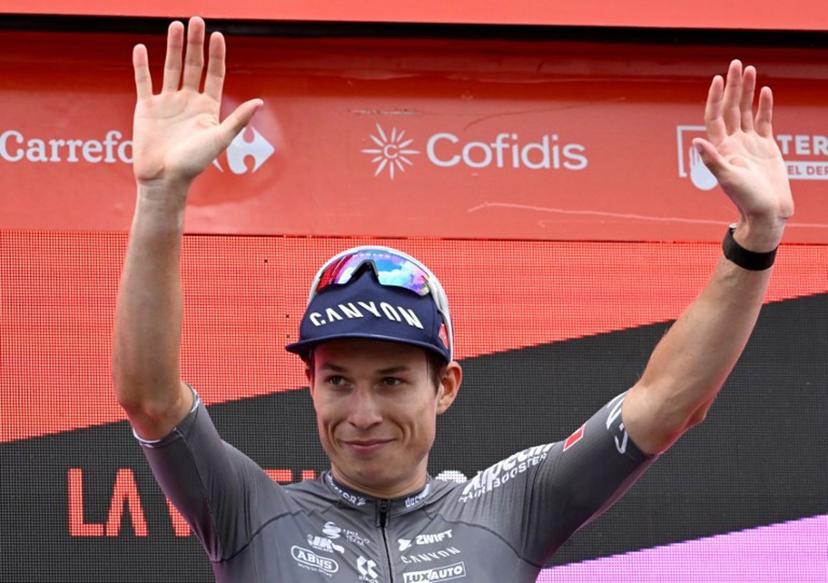 Stage winner team Alpecin's Belgian rider Jasper Philipsen celebrates on the podium after the 19th stage of the Vuelta a Espana, a 159 km race between Rueda and Guijuelo, on September 12, 2025.    Miguel RIOPA / AFP