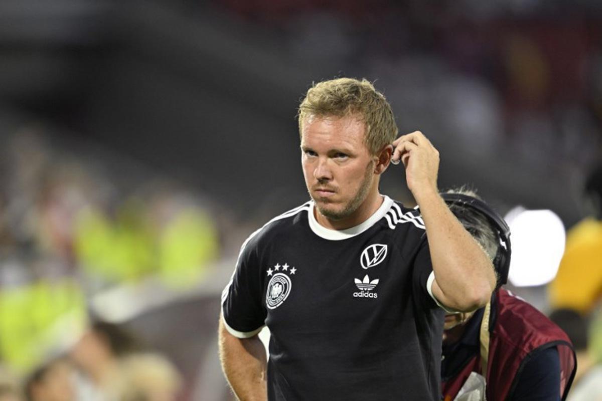 Germany's headcoach Julian Nagelsmann adjusts the earpiece as he wears the national team jersey prior to the start of the 2026 World Cup qualifiers Europe zone group A football match between Germany and Northern Ireland on September 7, 2025 in Cologne, western Germany.  INA FASSBENDER / AFP