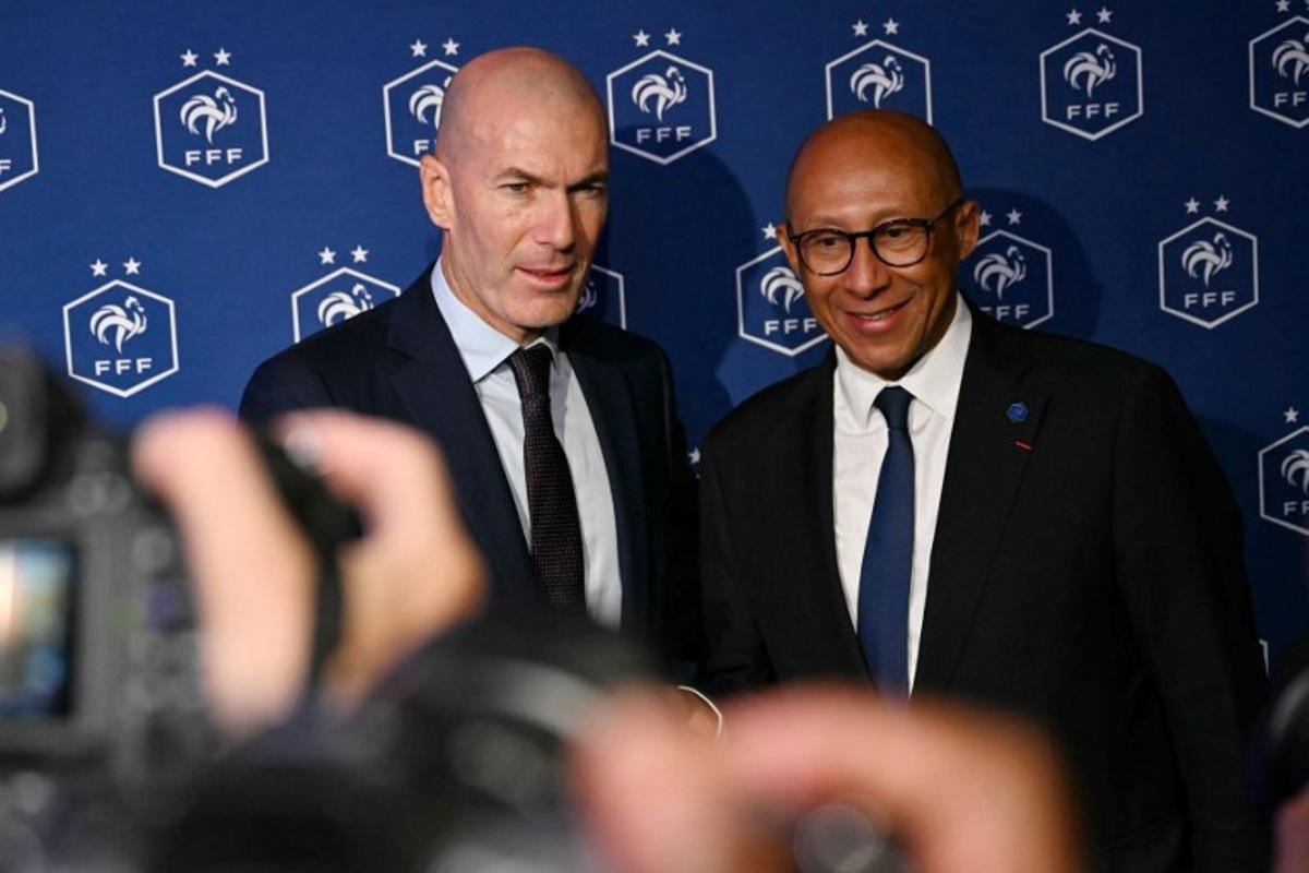 Former French international football player Zinedine Zidane (L) and President of the French Football Federation (FFF) Philippe Diallo (R) pose after a press conference to present him as the new head coach of France national football team at the French Football Federation headquarters (FFF) in Paris on July 28, 2026. The former France playmaker, who won the 1998 World Cup and the 2000 European Championship as a player, has been appointed head coach of the French national team, succeeding Didier Deschamps, the French Football Federation (FFF) announced. Zidane takes over from his former teammate Deschamps, who had been in charge since 2012; Deschamps' tenure ended with a fourth-place finish at the 2026 World Cup, following a title win in 2018 and a final appearance in 2022.  LOU BENOIST / AFP