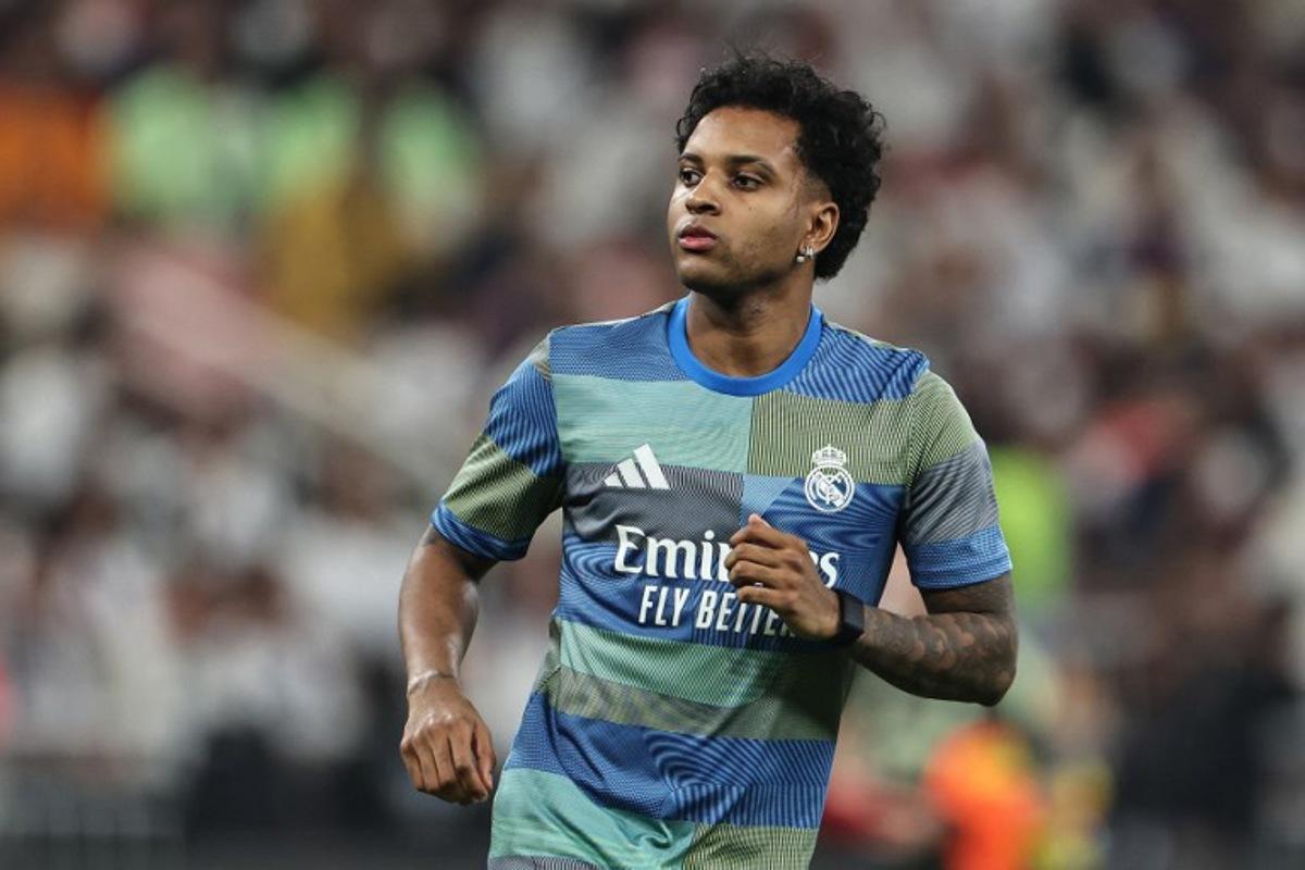 Real Madrid's Brazilian forward #11 Rodrygo warms up prior to the start of the Spanish Super Cup final football match between FC Barcelona and Real Madrid at the King Abdullah Stadium in Jeddah on January 11, 2026.  Fadel SENNA / AFP