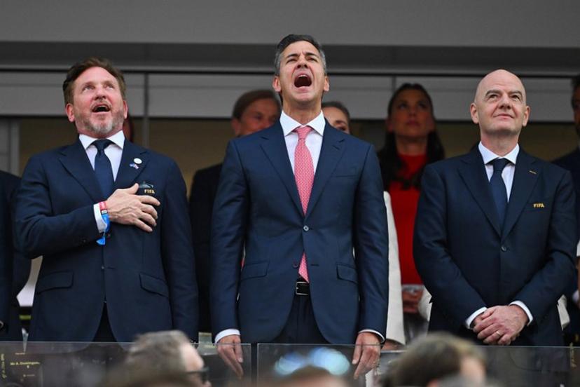 (L-R) CONMEBOL President Alejandro Dominguez and Paraguayan President Santiago Pena sing the Paraguayan national anthem next to FIFA president Gianni Infantino ahead of the 2026 World Cup Group D football match between USA and Paraguay at the Los Angeles Stadium in Inglewood on June 12, 2026.  Patrick T. Fallon / AFP