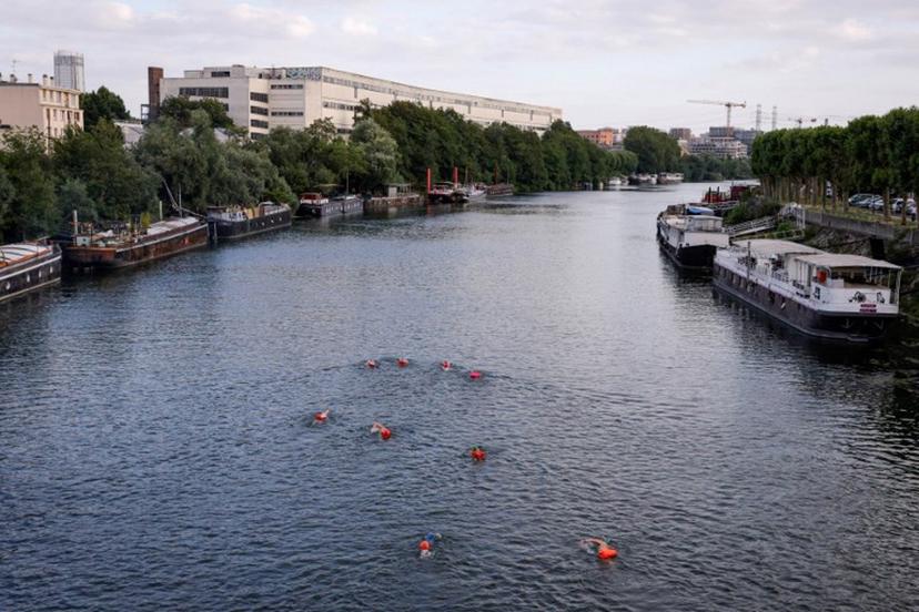 A group of swimmers enjoy the River Seine in Ile-Saint-Denis, north of Paris on July 2, 2023.   It is still prohibited to swim in the river Seine, but a year before the Olympic Games, which should inaugurate the reunion between this practice and the river, a group of pioneer swimmers fears neither the pollution, nor the Police. Geoffroy Van der Hasselt / AFP