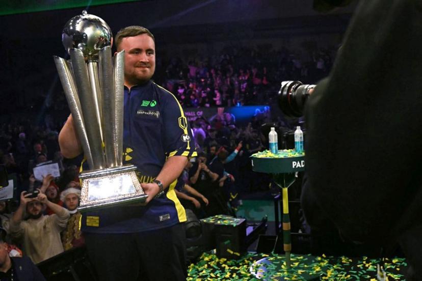 England's Luke Littler poses with the Sid Waddell Trophy after victory over Netherlands' Michael van Gerwen in the PDC World Darts Championship final, at Alexandra Palace in London on January 3, 2025. Luke Littler became darts' youngest world champion at just 17 after thrashing three-time winner Michael van Gerwen in front of an adoring home crowd at London's Alexandra Palace on Friday. This time there was no stopping "Luke the Nuke" as he stormed past Dutchman Van Gerwen by seven sets to three. Ben STANSALL / AFP