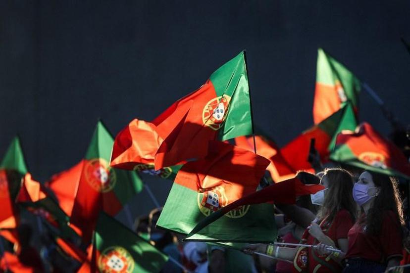 Supporters wave flags of Portugal during the FIFA World Cup Qatar 2022 European qualifying round group A football match between Portugal and Republic of Ireland at the Algarve stadium in Loule, near Faro, southern Portugal, on September 1, 2021.  CARLOS COSTA / AFP