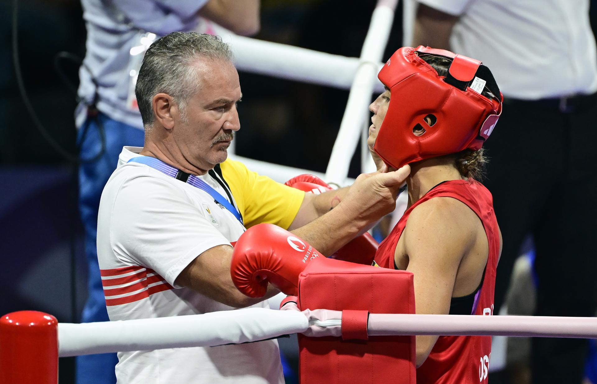 Raffaele Bergamasco and Belgian boxer Oshin Derieuw (red) pictured during a boxing bout between Belgian Derieuw and Chinese Yang, in the quarterfinal of the women's -66kg category at the Paris 2024 Olympic Games, on Saturday 03 August 2024 in Paris, France. The Games of the XXXIII Olympiad are taking place in Paris from 26 July to 11 August. The Belgian delegation counts 165 athletes competing in 21 sports. BELGA PHOTO DIRK WAEM