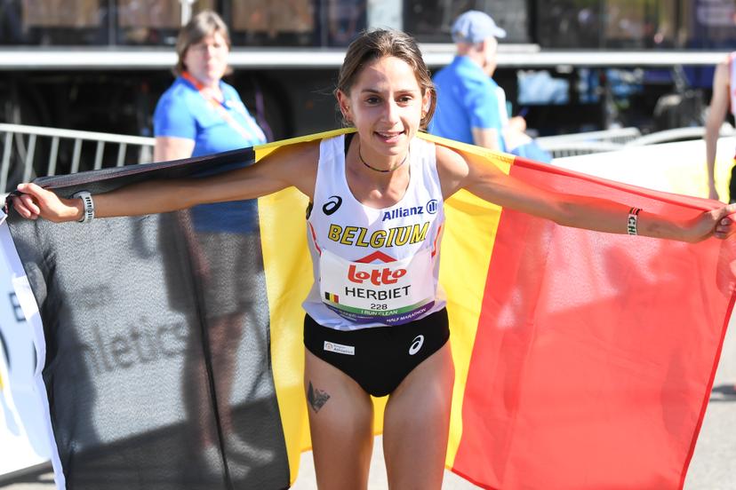 Belgian Chloe Herbiet celebrates after winning the half marathon race at European Running Championships, in Leuven, Saturday 12 April 2025. BELGA PHOTO JILL DELSAUX