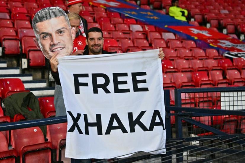 A fan of Switzerland's midfielder Granit Xhaka hlds up a banner in the crowd ahead of the UEFA Nations League, League B, Group 1 match football match between Scotland and Switzerland at Hampden Park in Glasgow, Scotland on September 29, 2026.    ANDY BUCHANAN / AFP