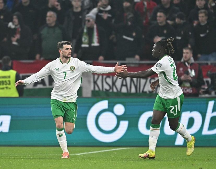 Ireland's forward #07 Troy Parrott (L) celebrates his 2-2 with Ireland's defender #21 Festy Ebosele during the FIFA World Cup 2026 Group F European qualification football match betweem Hungary and Republic of Ireland at the Puskas Arena in Budapest, Hungary on November 16, 2025.   Attila KISBENEDEK / AFP