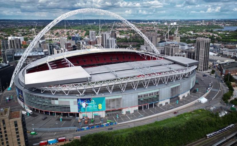 An aerial view taken on May 29, 2024, shows branding being attached to the outside of Wembley Stadium, venue for the UEFA Champions League final football match between Borussia Dortmund and Real Madrid, to be played in London on June 1, 2024.  Paul ELLIS / AFP