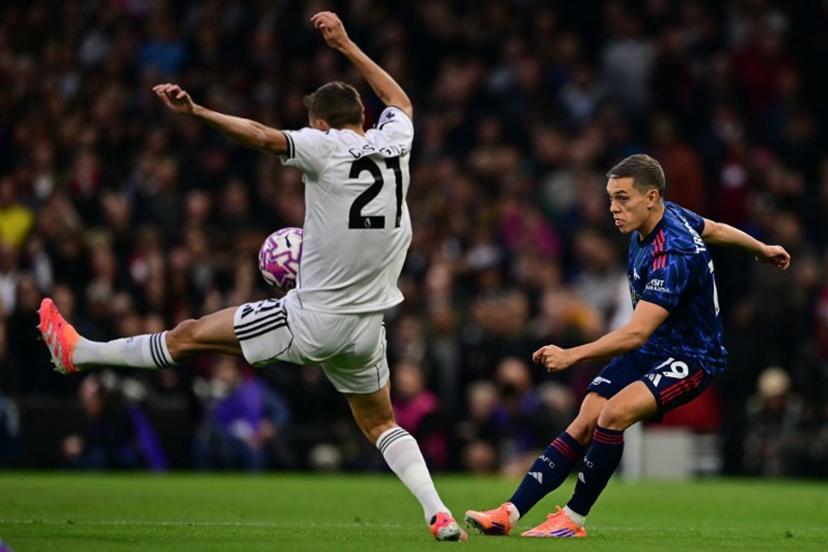 Arsenal's Belgian midfielder #19 Leandro Trossard (R) vies with Fulham's Belgian defender #21 Timothy Castagne (L) during the English Premier League football match between Fulham and Arsenal at Craven Cottage in London on October 18, 2025.  Ben STANSALL / AFP