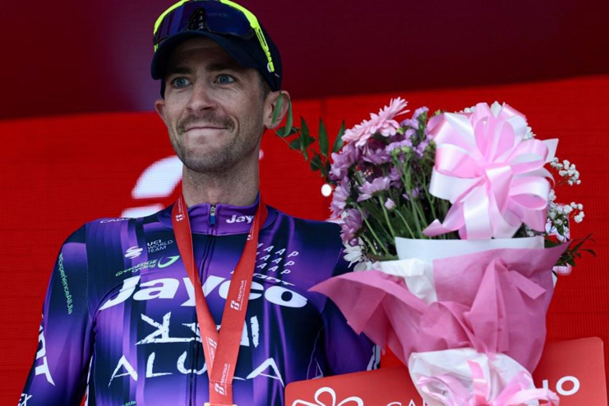 Team Jayco AlUla's Australian rider Chris Harper celebrates on the podium after winning the 20th stage of the 108th Giro d'Italia cycling race 205kms from Verres to Sestriere on May 31, 2025.  Luca Bettini / AFP