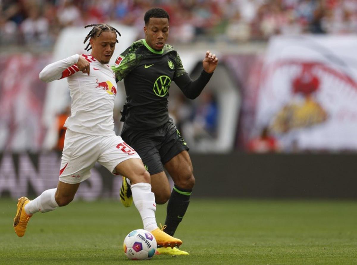 Leipzig's Dutch midfielder #20 Xavi Simons (L) and Wolfsburg's Belgian midfielder #06 Aster Vranckx vie for the ball during the German first division Bundesliga football match RB Leipzig v VfL Wolfsburg in Leipzig, eastern Germany on April 13, 2024.  Odd ANDERSEN / AFP