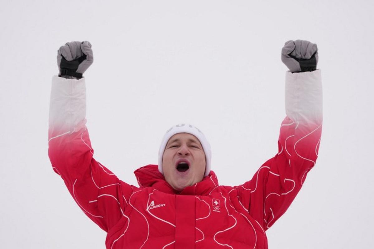 Silver medallist Switzerland's Marco Odermatt celebrates  on the podium of the men's giant slalom alpine skiing event during the Milano Cortina 2026 Winter Olympic Games at the Stelvio Ski Centre in Bormio (Valtellina) on February 14, 2026.  Dimitar DILKOFF / AFP