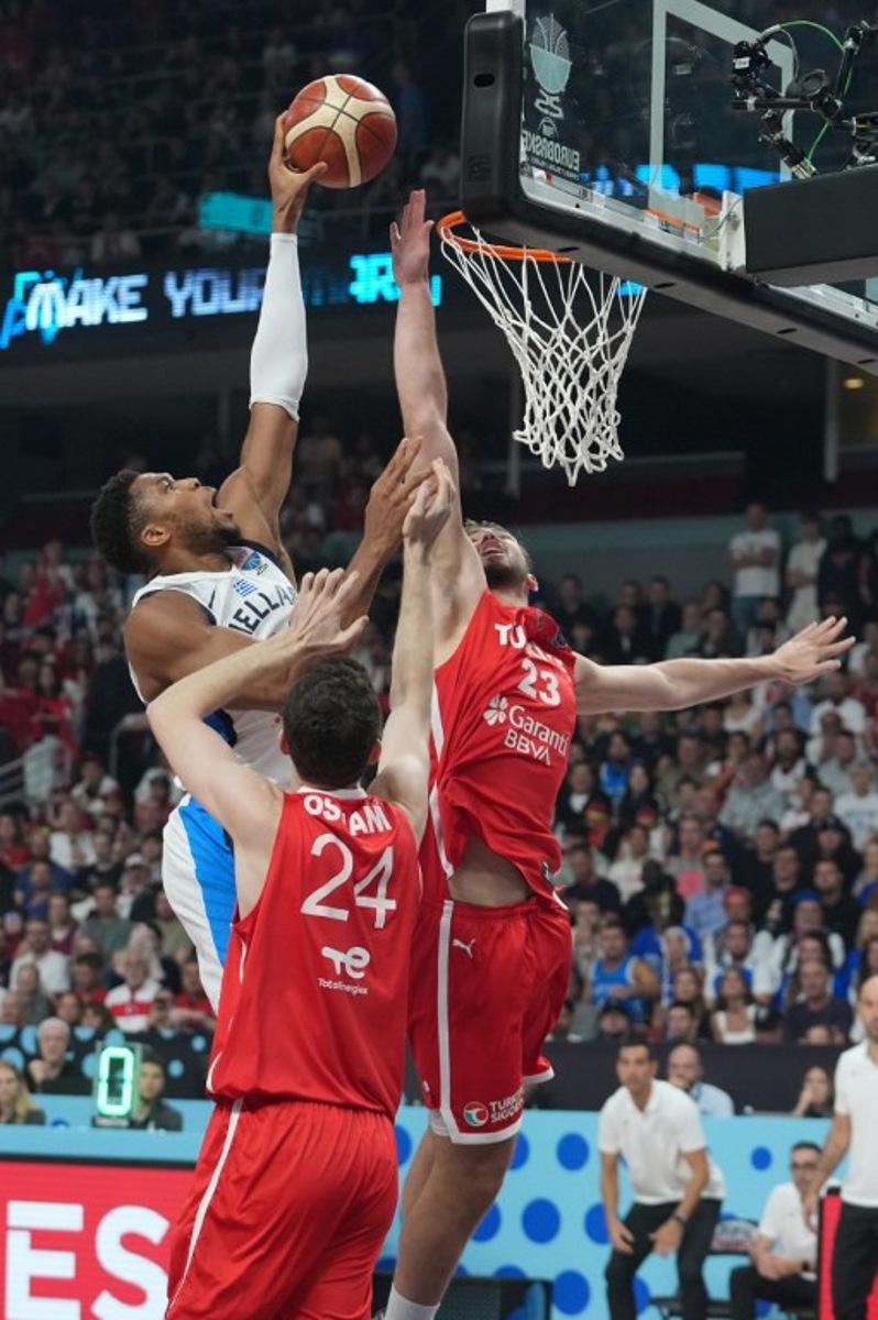 Greece's small forward #34 Giannis Antetokounmpo (L), Turkey's center #24 Ercan Osmani (C) and Turkey's power forward #23 Alperen Sengun vie for the ball during the FIBA EuroBasket 2025 semi-final basketball match between Greece and Turkey in Riga, Latvia, on September 12, 2025.  Gints Ivuskans / AFP