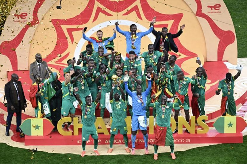 Senegal players celebrate with the trophy after winning the Africa Cup of Nations (CAN) final football match against Morocco at the Prince Moulay Abdellah Stadium in Rabat on January 18, 2026.   Paul ELLIS / AFP