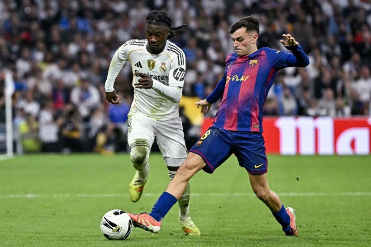 Real Madrid's French midfielder #06 Eduardo Camavinga (L) vies for the ball with Barcelona's Spanish midfielder #08 Pedri during the Spanish league football match between Real Madrid CF and FC Barcelona at the Santiago Bernabeu stadium in Madrid on October 26 , 2025.  JAVIER SORIANO / AFP