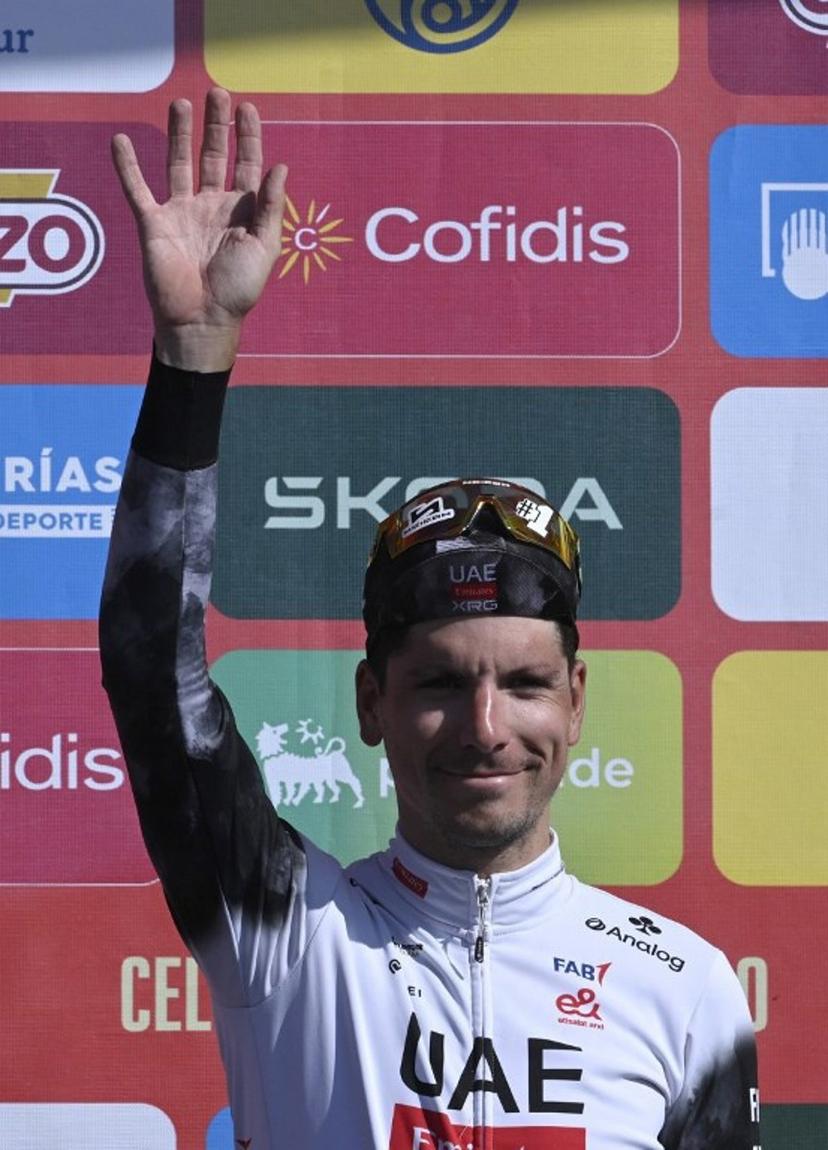 Stage winner, team UAE's Portuguese rider Joao Almeida celebrates on the podium after the 13th stage of the Vuelta a Espana, a 202 km race between Cabezon de la Sal and L'Angliru, on September 5, 2025.    Miguel RIOPA / AFP