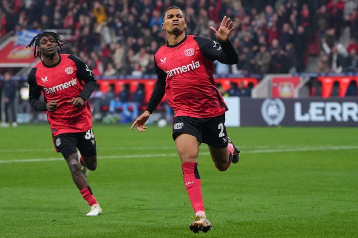 Bayer Leverkusen's French forward #21 Amine Adli (R) celebrates scoring the 3-1 goal with his teammate Dutch defender #30 Jeremie Frimpong during the German first division Bundesliga football match between Bayer 04 Leverkusen and VfL Bochum in Leverkusen, western Germany on March 28, 2025.  Pau BARRENA / AFP