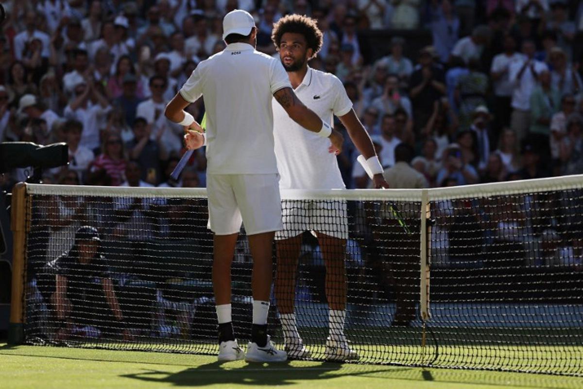 Italy's Matteo Berrettini is congratulated by France's Arthur Fils for winning their men's singles second round tennis match on the fourth day of the 2026 Wimbledon Championships at The All England Lawn Tennis and Croquet Club in Wimbledon, southwest London, on July 2, 2026.  Adrian Dennis / AFP