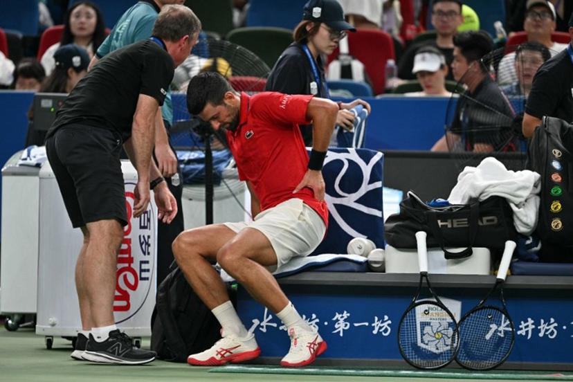 Serbia's Novak Djokovic receives medical attention during his men's singles semi-final match against Monaco's Valentin Vacherot at the Shanghai Masters tennis tournament in Shanghai on October 11, 2025.  Hector RETAMAL / AFP