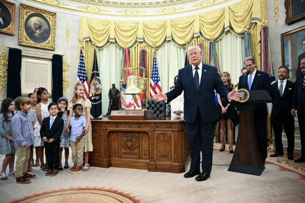 US President Donald Trump (R) speaks at the launch of Trump investment accounts in the Oval Office of the White House in Washington, DC, on July 6, 2026. Trump accounts are a new type of tax-deferred investment accounts for children. Mandel NGAN / AFP