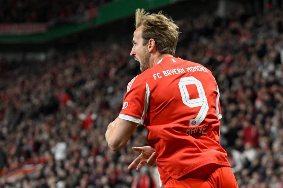 Bayern Munich's English forward #09 Harry Kane celebrates scoring the opening goal with his teammates during the German Cup (DFB-Pokal) semi-final football match between Bayer 04 Leverkusen and FC Bayern Munich in Leverkusen, western Germany on April 22, 2026.  INA FASSBENDER / AFP