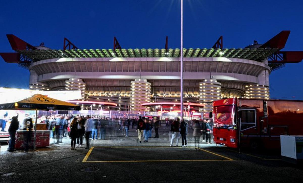 This slow shutter speed exposure image shows food tracks selling assorted food outside the stadium prior to the Italian Serie A football match between AC Milan and Pisa SC at San Siro stadium in Milan, northern Italy, on October 24, 2025.  Stefano RELLANDINI / AFP