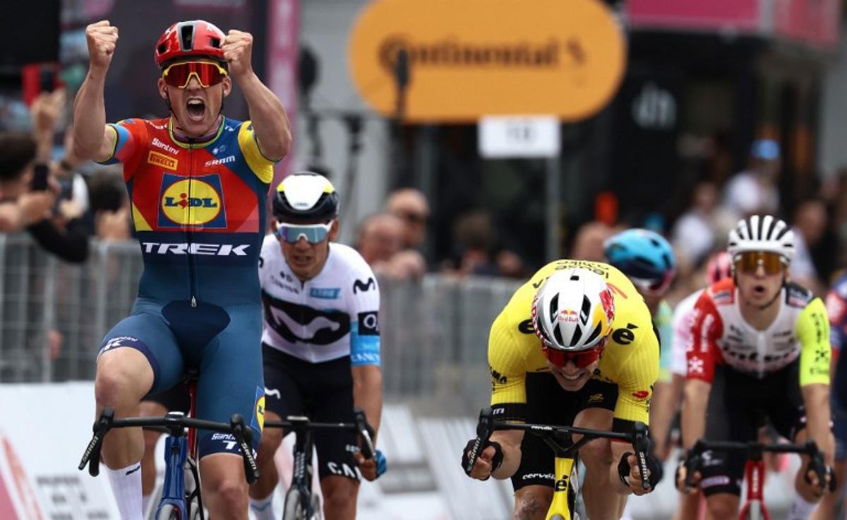 Lidl-Trek's Danish rider Mads Pedersen, next to Team Visma-Lease a Bike's Belgian rider Wout Van Aert (R), celebrates as he crosses the finish to win the first stage of the 108th Giro d'Italia cycling race, 160km from Durres to Tirana in Albania, on May 9, 2025.   Luca Bettini / AFP